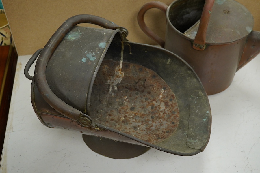 A copper watering can and a helmet coal scuttle, watering can 40cm high. Condition - interior of coal scuttle rusty, both need cleaning